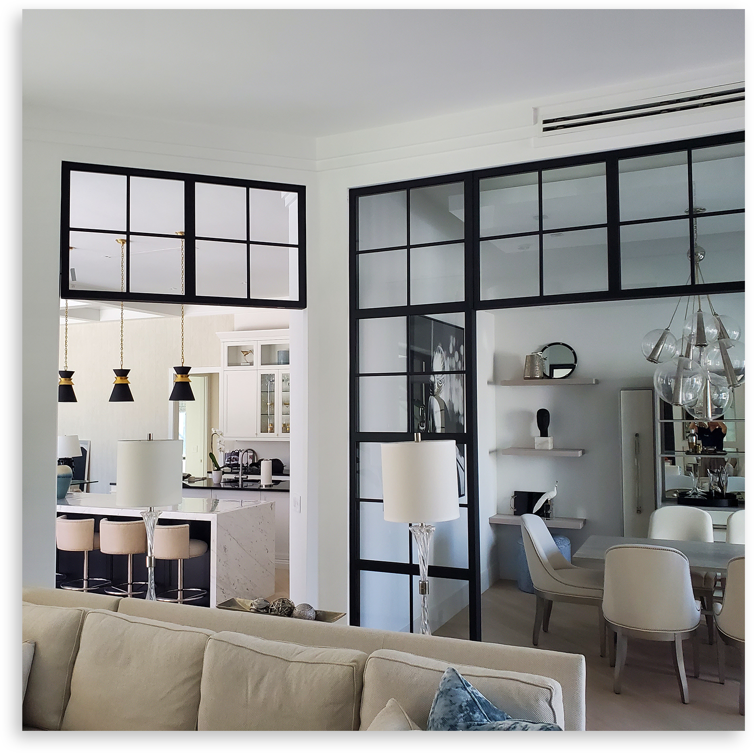 Urban Pure steel-look glass partitions dividing a living room from the kitchen and dining areas