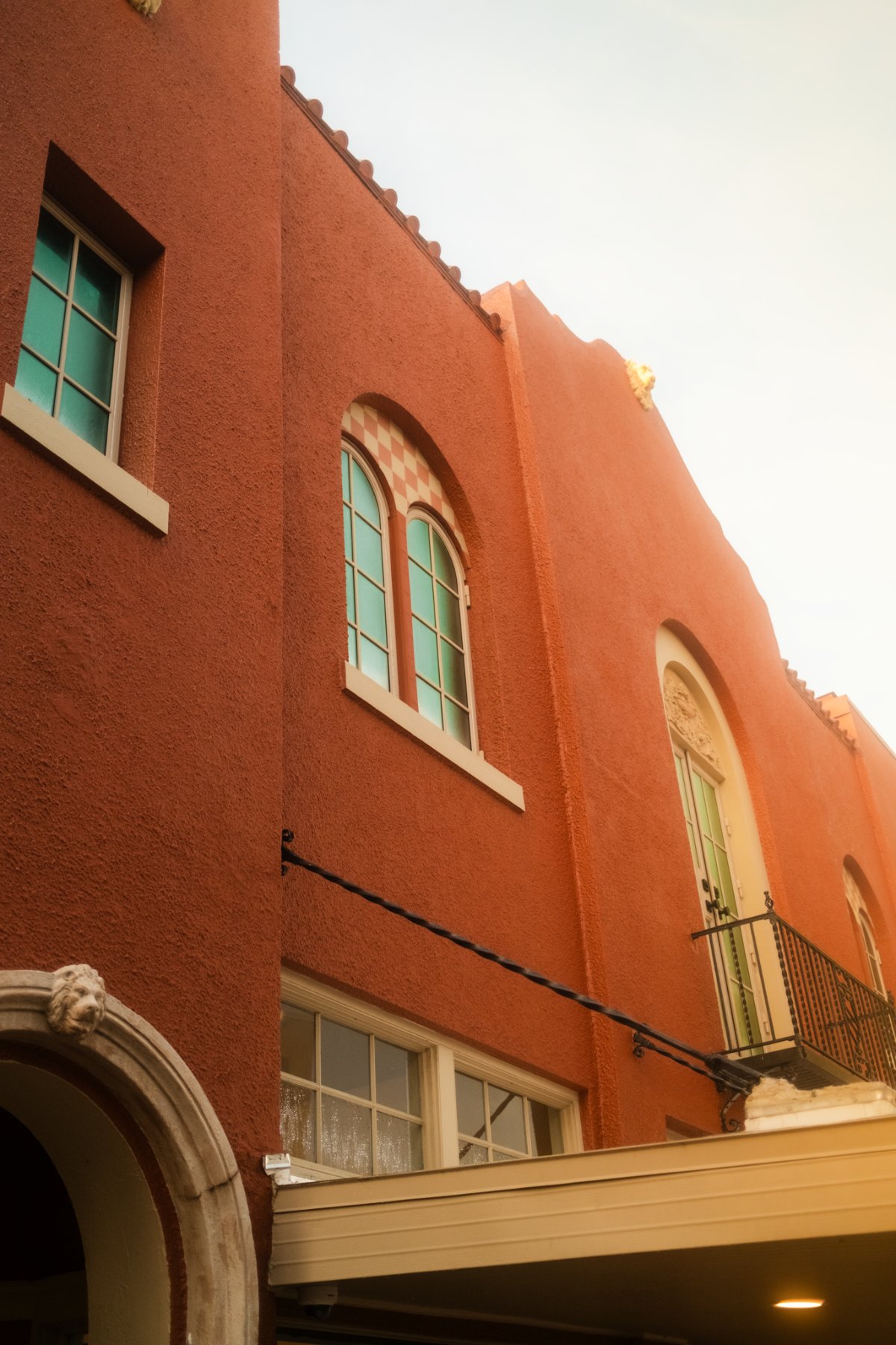 Arched steel windows on stucco facade